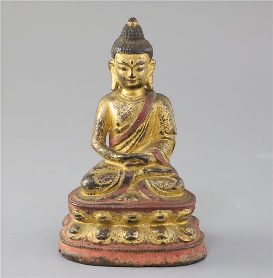 A Sino-Tibetan gilt and polychrome bronze seated figure of Buddha Shakyamuni, 17th/18th century, H. 16.5cm